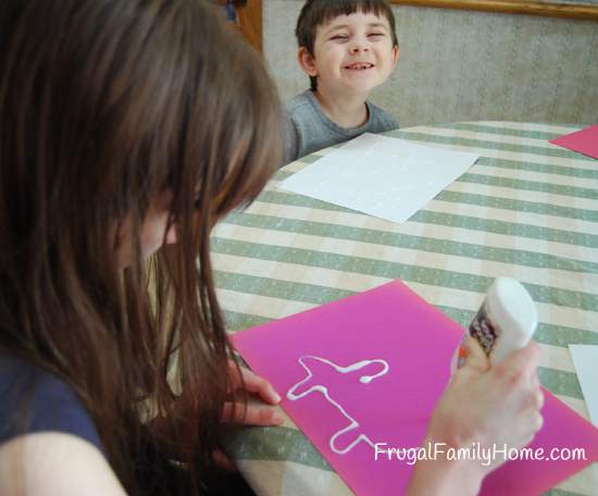 Kids applying the glue for Salt Painting