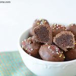 Brownie truffles in a bowl with one cut so you can see inside.