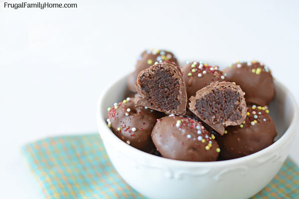 Brownie truffles in a bowl with one cut so you can see inside.
