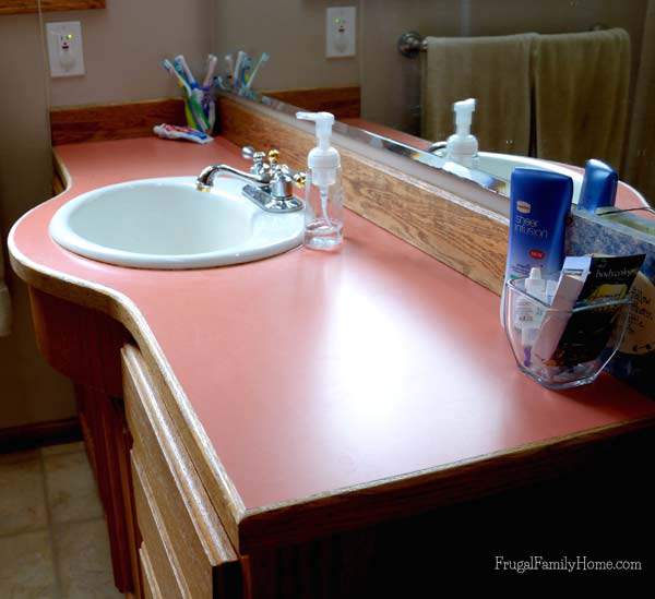 A good photo of the old peach countertops in our bathroom | Frugal Family Home
