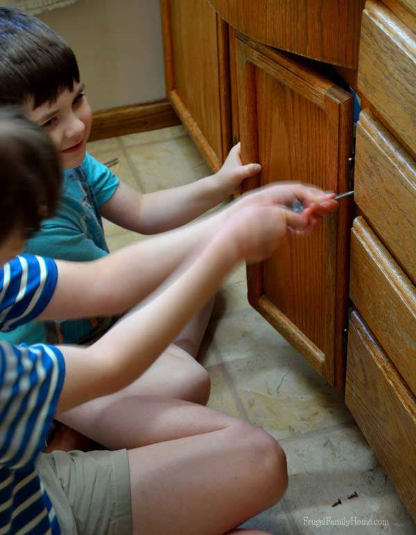The kids helping with taking apart the vanity | Frugal Family Home