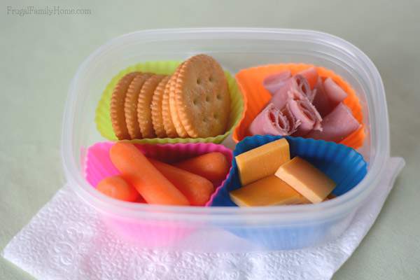 Use old lunchmeat containers and silicone muffin cups to make your own Lunchables | Frugal Family Home