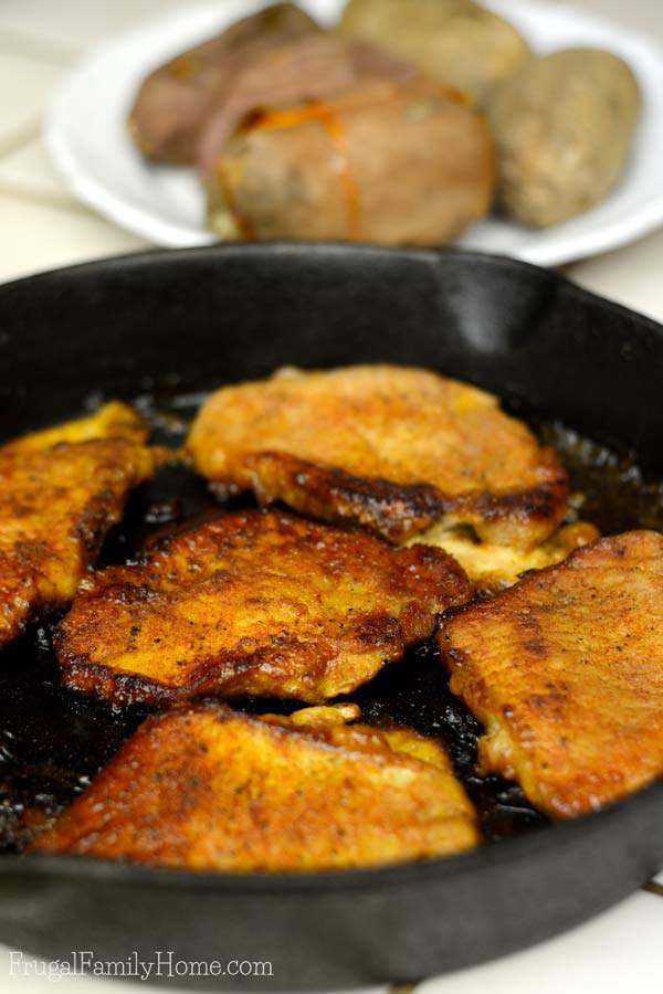 Glazed pork chops cooked in a pan ready to serve.