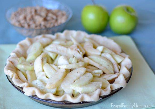 I know this time of year I love to make apple recipes. Apple pie is one of my favorite fall desserts. If you also love to enjoy apples you’re going to want to give this Apple Crumble Pie Recipe a try. It has a crunchy topping over slightly tart apples that make the best pie ever. 