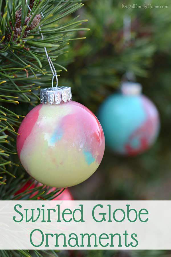 My kids had a great time making this Christmas ornaments, even though I was the one to drop and break one while it was full of paint. We used a glitter paint and watermelon red to make our swirled paint ornaments.