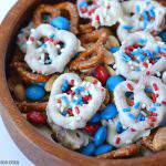 This is an easy to make patriotic pretzel snack mix. It’s perfect for your fourth of July celebration. It would be great to serve as a snack while waiting for the burgers to get done on the grill. Or for the kids to snack on it while you are waiting for the fireworks to begin. It’s so easy even the kids can help to make this recipe.