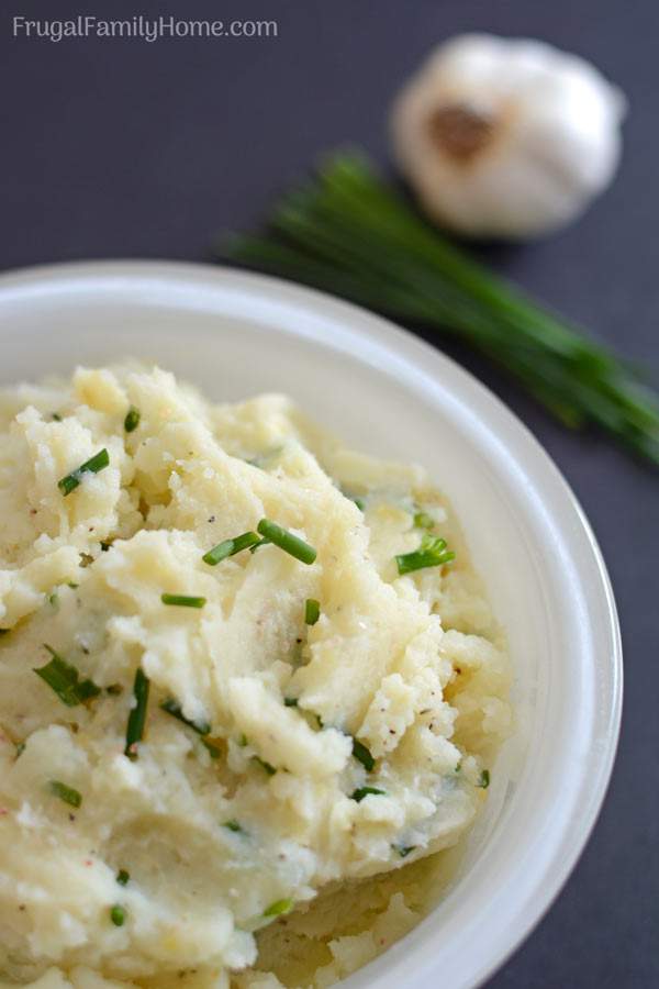 An easy creamy homemade mashed potatoes recipe with garlic and chives. These are so delicious and they can be made ahead and reheated when it’s time to serve. 