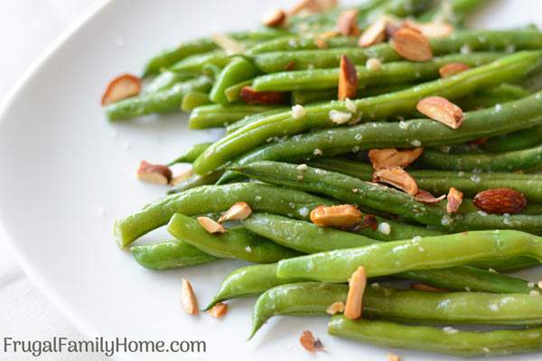 Ginger Garlic Green Beans, this green bean side dish recipe is made with fresh, frozen or canned green beans. It’s asian inspired with garlic and ginger to season the green beans and sprinkled with almonds to make an elegant but super easy sautéed side dish.