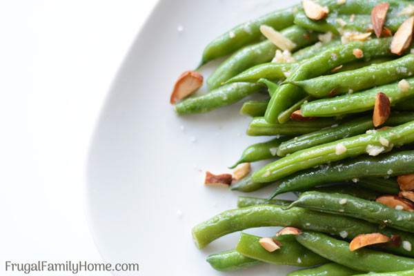 Ginger Garlic Green Beans, this green bean side dish recipe is made with fresh, frozen or canned green beans. It’s asian inspired with garlic and ginger to season the green beans and sprinkled with almonds to make an elegant but super easy sautéed side dish.