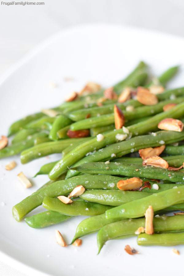 Ginger Garlic Green Beans, this green bean side dish recipe is made with fresh, frozen or canned green beans. It’s asian inspired with garlic and ginger to season the green beans and sprinkled with almonds to make an elegant but super easy sautéed side dish.