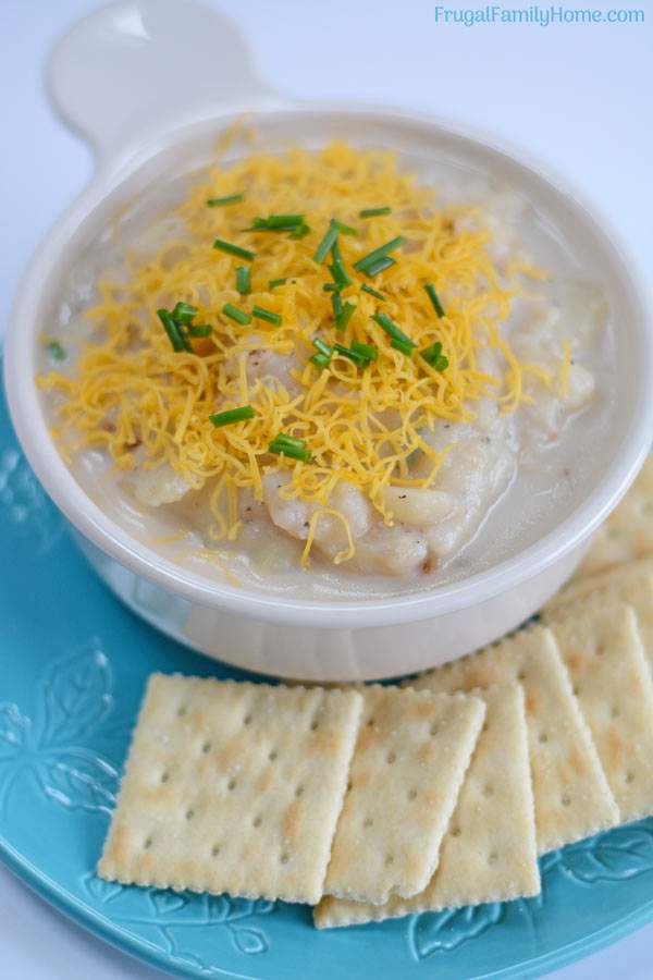 Simple potato soup recipe in a bowl with cheese on top.