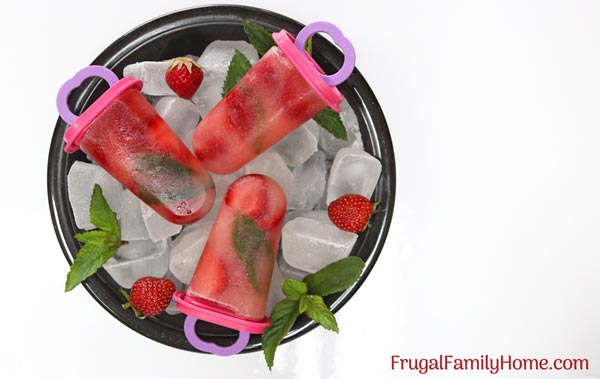 A bowl of homemade popsicles, strawberry mint popsicles.