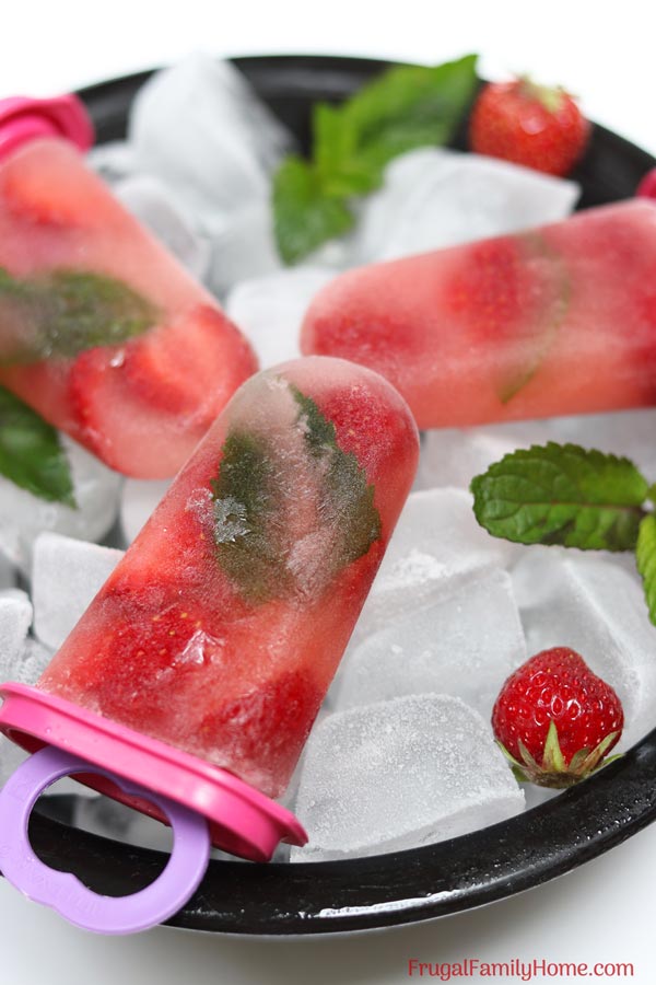 strawberry mint popsicles in a bowl.