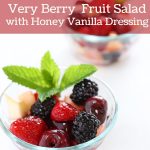 Very berry fruit salad with honey vanilla dressing in a serving bowl.