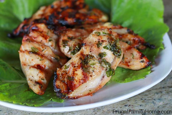 cooked garlic parsley chicken recipe on a plate with lettuce.