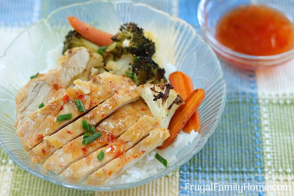 Sweet chili chicken upclose with side dipping sauce of sweet chili sauce.