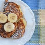 The easy banana pancakes on a plate ready to serve with bananas on top.