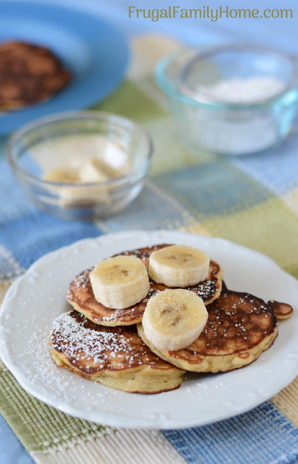 Banana bread pancakes served with bananas and powdered sugar