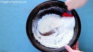 Stirring the flour in the bowl.