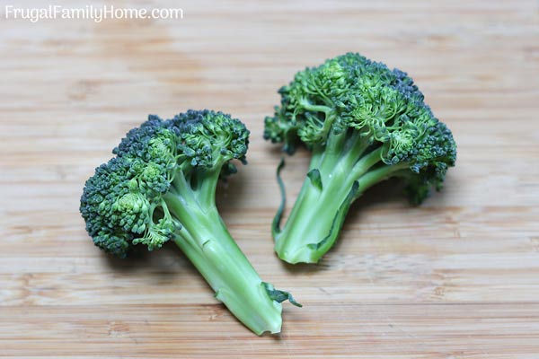 broccoli florets on a cutting board.