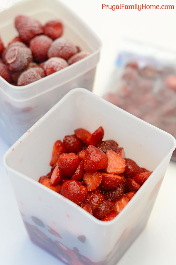 Three different containers for frozen strawberries.