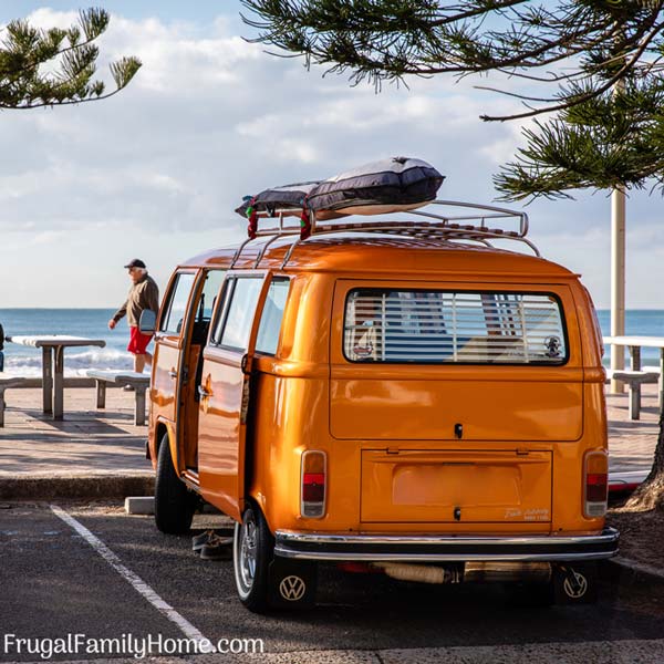 A van at the beach for a road trip.