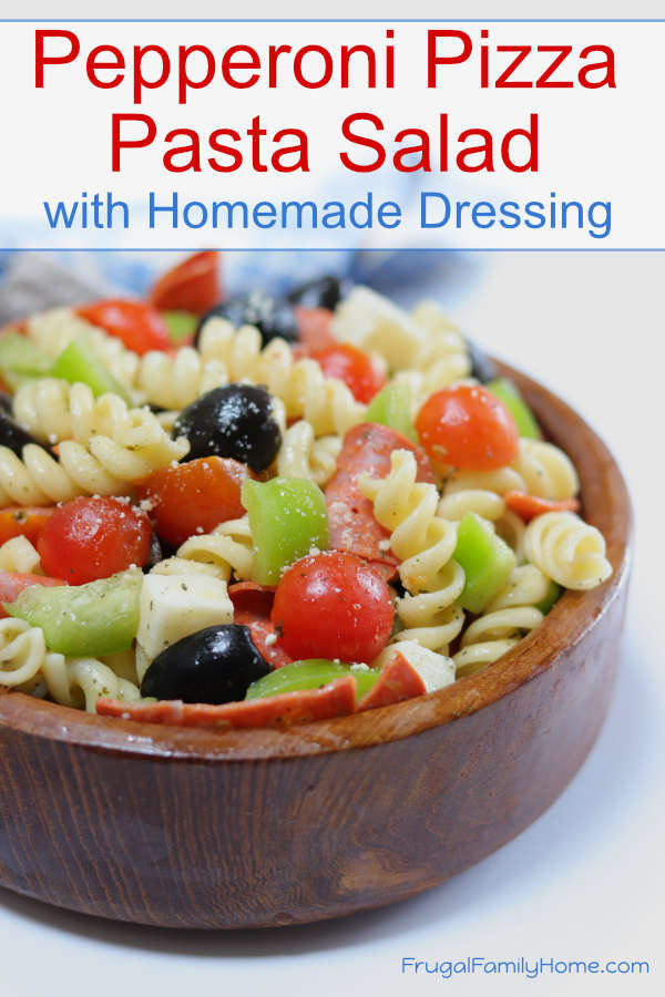 Pepperoni pizza pasta salad ready to serve in a bowl with homemade dressing.