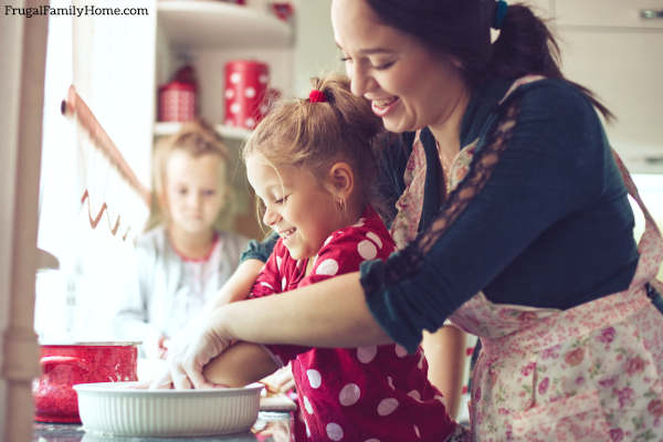 mom with kids cooking together in kitchen.
