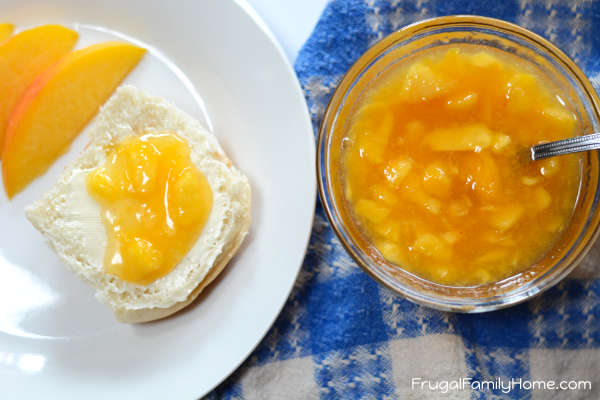 A serving of peach jam on a roll.
