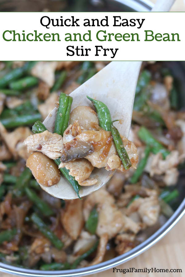 A skillet with chicken and green bean stir fry ready to eat.