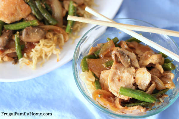 A single serving of chicken and green bean stir fry.