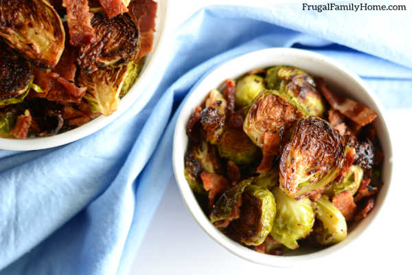 a serving bowl of brussels spouts with bacon from oven.