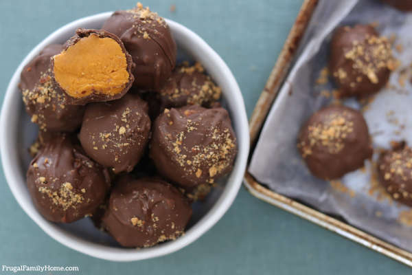 Transferring the homemade truffles to a bowl.