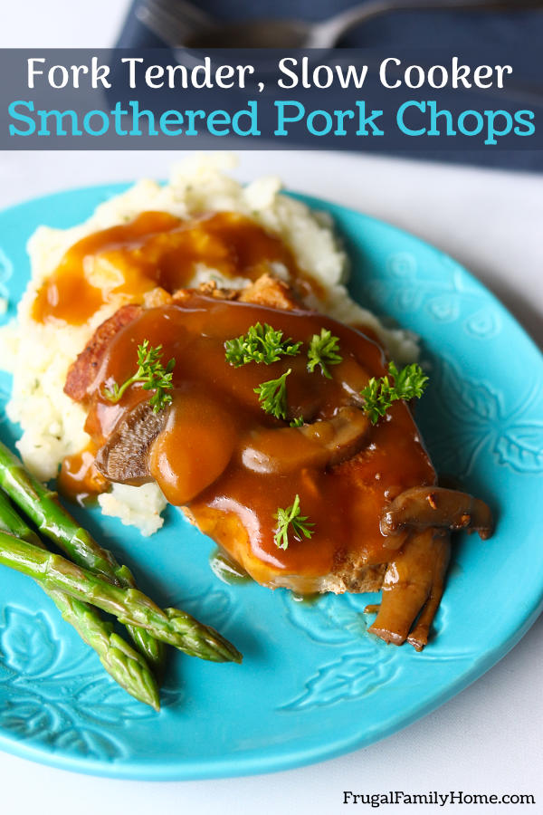 Smothered pork chops on a plate.