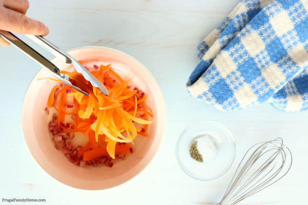 mixing the carrots with the dressing