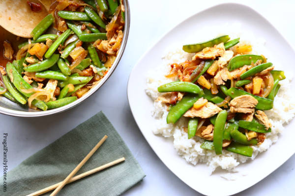 a plate of stir fry on top or rice.