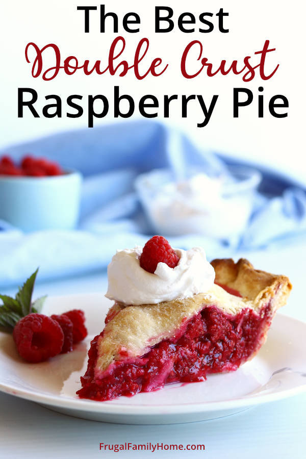 Slice of homemade raspberry pie with whipped cream and raspberry on top.