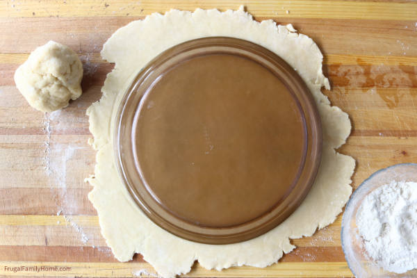 Measuring the homemade pie crust.