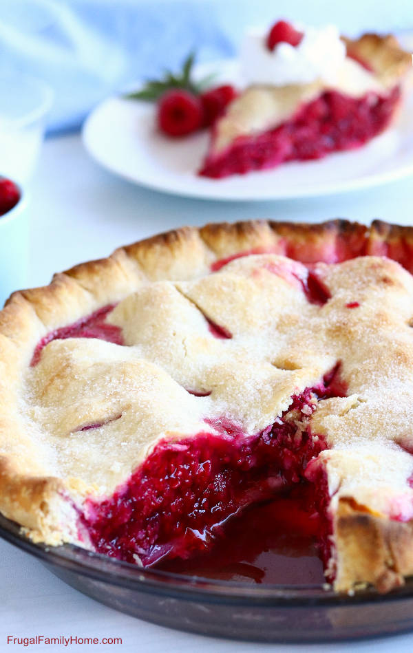 A slice cut out of the raspberry pie made from scratch