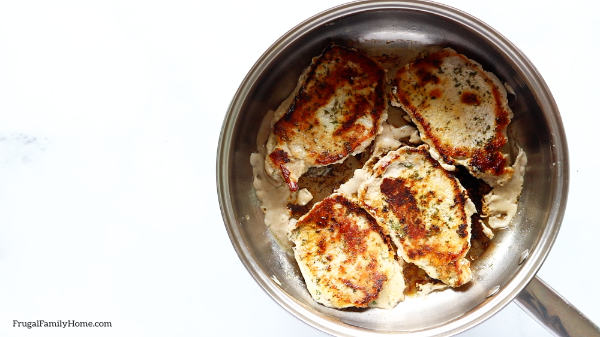 Pork chops browned in the pan.