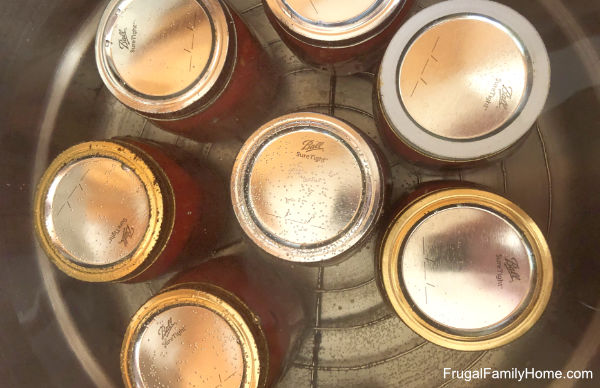 jars of tomatoes in the water bath canner