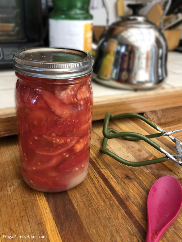 Jar of tomatoes ready to go into the canner.
