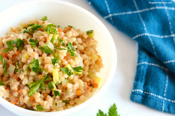 Vegetable couscous in a bowl sprinkled with parsley.