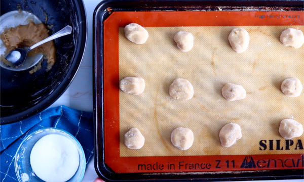 cookie dough balls on the sheet pan
