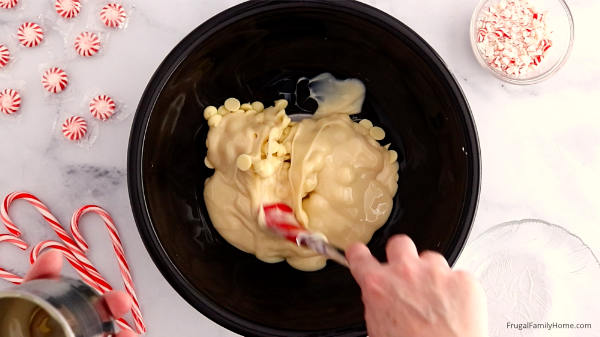mixing the white chocolate chips with milk for fudge