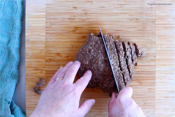 cutting the thawed, cooked, drained ground beef