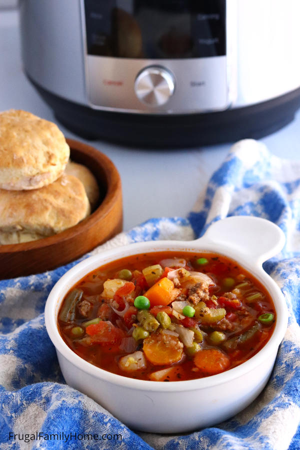 A serving of instant pot soup with homemade biscuits.