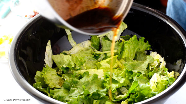 Dressing the salad with hot bacon dressing