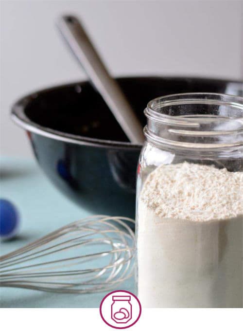 Mixing bowl, spoon, and jar of flour