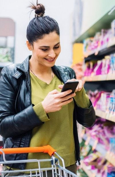 A person happy to be shopping for groceries.